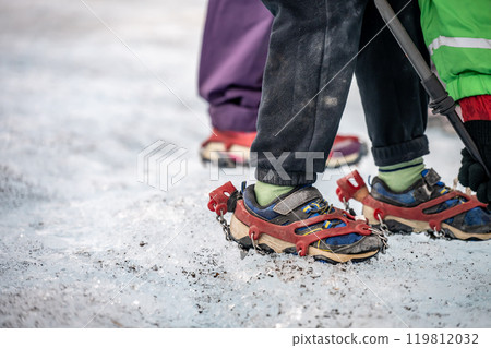 Selective focus on chain spikes on a pair of shoes for added traction on ice.  119812032