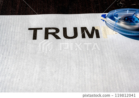 Correction tape being used to white out a paper with letters Correction tape being used to white out a paper with letters 119812041
