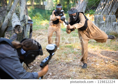 Attack of the paintball team on the enemy at army training ground Attack of the paintball team on the enemy at army training ground 119812224