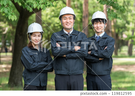 身穿林業和土木工程工作服的男女工人在森林裡雙臂交叉 119812595