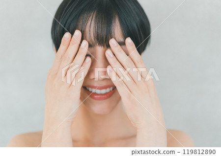 A woman whose eyes are hidden by hand 119812890