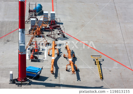 Towbars for different airplanes, aircraft steps and signal cones at the airport apron Towbars for different airplanes, aircraft steps and signal cones at the airport apron 119813155