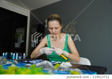 The process of making the art decor of epoxy resin, natural stones and moss 119813712