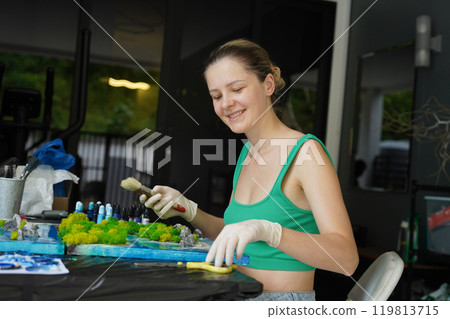 The process of making the art decor of epoxy resin, natural stones and moss 119813715