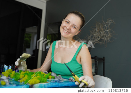 The process of making the art decor of epoxy resin, natural stones and moss 119813716