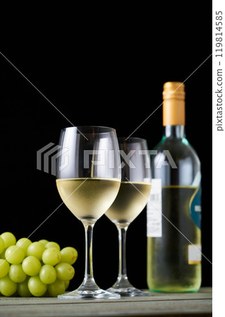 white wine poured into a glass white wine poured into a glass 119814585