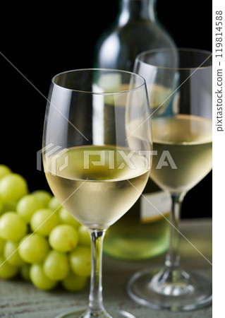 white wine poured into a glass 119814588