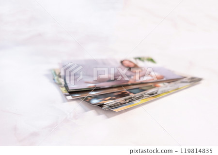 woman sitting at desk and looking at printed photos, remember nostalgia for a day of rest. photography cards, background. Mock up woman sitting at desk and looking at printed photos, remember nostalgia for a day of rest. photography cards, background. Mock up 119814835