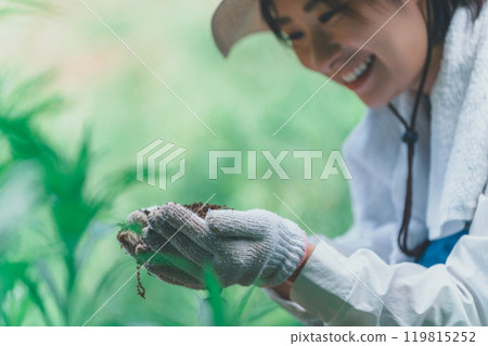 Farmer looking at the soil Farmer looking at the soil 119815252