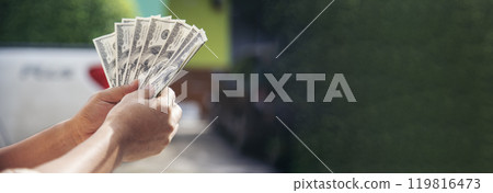 Banner Hand holding loan money dollar bank note financial payment. Banner Man hands showing spread 100 dollar exchange cash with copy space. Saving Businessman money banknote bribe corruption concept 119816473