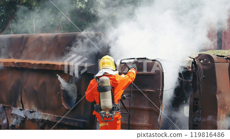Firefighter fighting smoke flame use fire hose chemical water foam spray engine. Firefighter Rescue training in fire fighting extinguisher. Fireman wear hard hat safety suit uniform for protection 119816486