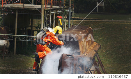 Firefighter fighting smoke flame use fire hose chemical water foam spray engine. Firefighter Rescue training in fire fighting extinguisher. Fireman wear hard hat safety suit uniform for protection 119816487