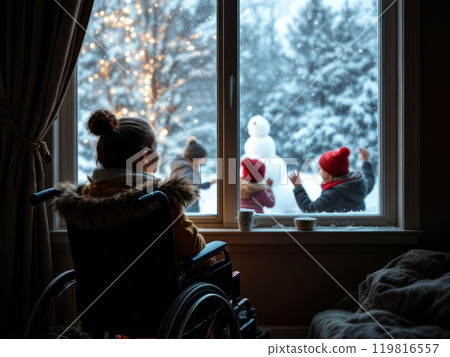 Teenage girl wheelchair user watches children playing in winter on  playground from window of dark room. 119816557