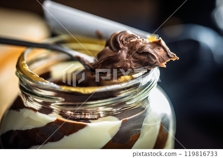 Chocolate cream spread on spoon. Chocolate cream spread on spoon. 119816733