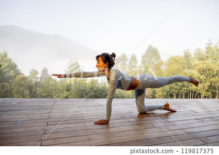Morning Yoga in Nature's Embrace 119817375