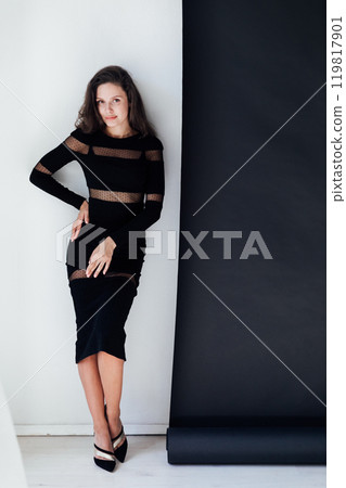 Beautiful fashionable slim woman in black evening dress Beautiful fashionable slim woman in black evening dress 119817901