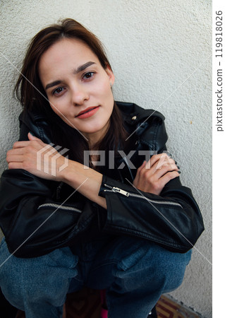 Portrait of a beautiful fashionable slender woman in a black leather jacket 119818026