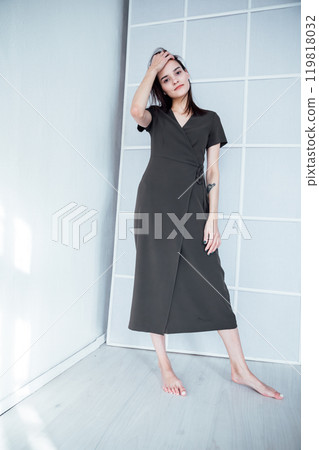 beautiful fashionable slender woman in a gray summer dress on a white background 119818032