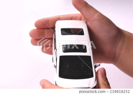 Child's hand holding a miniature car 119818252