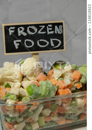 Frozen mixed vegetables for long-term storage with blackboard label and text FROZEN FOOD. Deep freezing of vegetables. defrosting Frozen food background 119818923