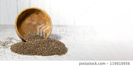 Chia seeds fall from wooden bowl. Healthy superfood rich in Omega 3 fatty acids. Dry healthy natural ingredient. Chia grains are falling Chia seeds fall from wooden bowl. Healthy superfood rich in Omega 3 fatty acids. Dry healthy natural ingredient. Chia grains are falling 119818956