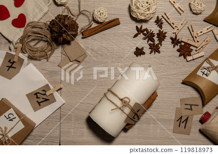 Unrecognizable young woman paint numbers on candles. Female making homemade advent calendar Made with your own hands step by step DIY crafts do it yourself. Preparation to christmas concept. Seasonal Unrecognizable young woman paint numbers on candles. Female making homemade advent calendar Made with your own hands step by step DIY crafts do it yourself. Preparation to christmas concept. Seasonal 119818973