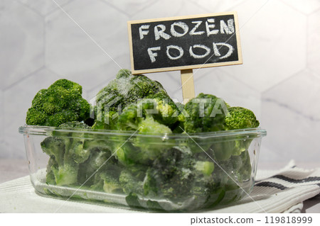 Frozen food broccoli florets with blackboard label and text FROZEN FOOD homemade. Harvesting concept. Stocking up vegetables for winter storage. Healthy food Frozen food broccoli florets with blackboard label and text FROZEN FOOD homemade. Harvesting concept. Stocking up vegetables for winter storage. Healthy food 119818999
