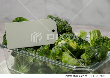 Frozen food broccoli florets with empty paper note copy space for text homemade. Harvesting concept. Stocking up vegetables for winter storage. Healthy food Frozen food broccoli florets with empty paper note copy space for text homemade. Harvesting concept. Stocking up vegetables for winter storage. Healthy food 119819019
