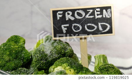 Frozen food broccoli florets with blackboard label and text FROZEN FOOD homemade. Harvesting concept. Stocking up vegetables for winter storage. Healthy food Frozen food broccoli florets with blackboard label and text FROZEN FOOD homemade. Harvesting concept. Stocking up vegetables for winter storage. Healthy food 119819025