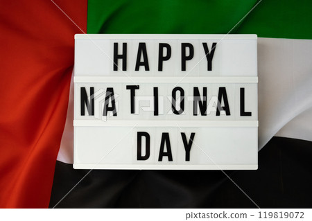 Text HAPPY NATIONAL DAY on background waving flag of UAE. National holiday of United Arab Emirates. Commemoration Day Muslim Arabian holidays. Dubai 119819072