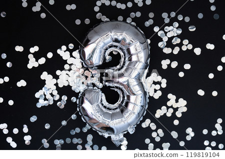 3 three metallic balloon with sparkling confetti on dark black background. Greeting card silver foil balloon number Happy birthday holiday concept. Copy space for text. Celebration party 3 three metallic balloon with sparkling confetti on dark black background. Greeting card silver foil balloon number Happy birthday holiday concept. Copy space for text. Celebration party 119819104
