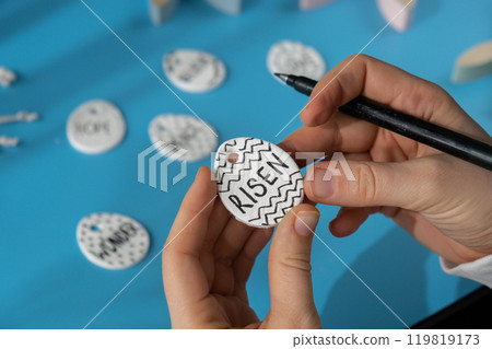 Master class writing word RISEN on EASTER clay egg Children air dry clay activity handicraft idea. DIY process step by step instruction. Preparing for Easter holiday decorating. Modern organic design 119819173