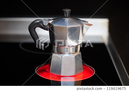 Prepare and serve coffee with an Italian coffee maker Prepare and serve coffee with an Italian coffee maker 119819675