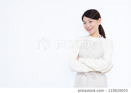 A housewife thinking with her arms folded A housewife thinking with her arms folded 119820055