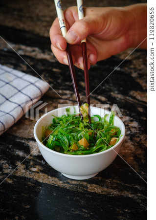 Wakame salad in a bowl and bamboo sticks Wakame salad in a bowl and bamboo sticks 119820656