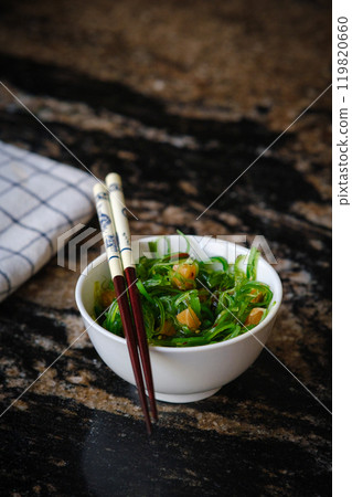 Wakame salad in a bowl and bamboo sticks Wakame salad in a bowl and bamboo sticks 119820660