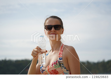 A young woman enjoying a beautiful day at the beach A young woman enjoying a beautiful day at the beach 119820683