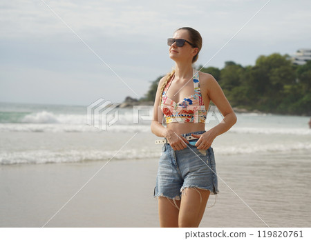A young woman enjoying a beautiful day at the beach  119820761