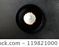 cake basket with protein cream in a black round plate on a black background 119821000