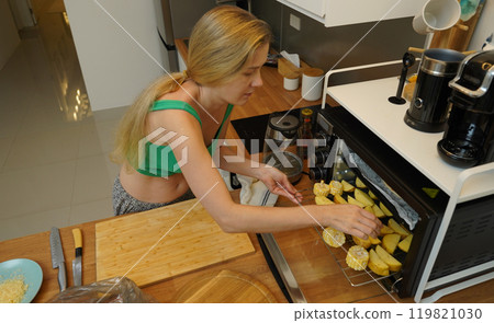 A young woman joyfully prepares a variety of healthy meals  119821030