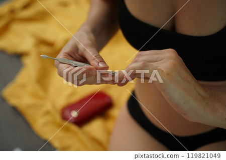 A woman doing a manicure and pedicure 119821049