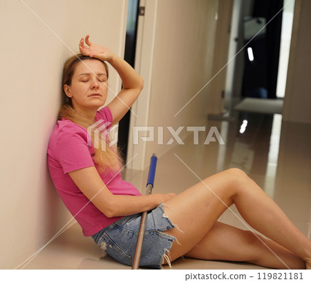 A woman is cleaning her living room at home A woman is cleaning her living room at home 119821181