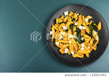 Cooked vegetarian pumpkin dumplings. 119821441