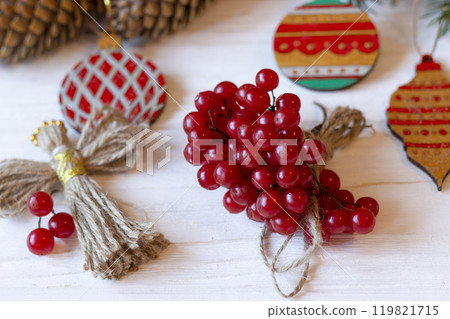 DIY decorations for Christmas. Xmas card. Christmas composition with Ukrainian doll-motanka, wooden balls, snowball tree, cones and fir branches. New Year eco-conscious handmade toys. Happy holidays. DIY decorations for Christmas. Xmas card. Christmas composition with Ukrainian doll-motanka, wooden balls, snowball tree, cones and fir branches. New Year eco-conscious handmade toys. Happy holidays. 119821715