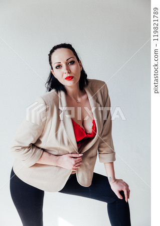 Beautiful plump brunette woman in a business suit Beautiful plump brunette woman in a business suit 119821789