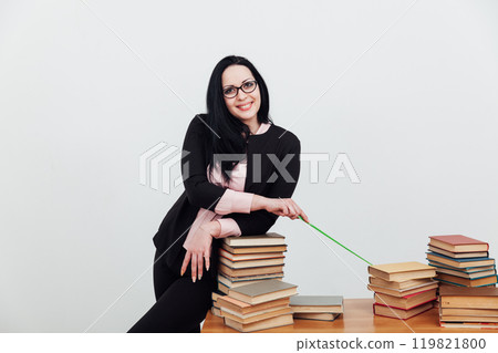 business woman teacher, a librarian and many stacks of books to read 119821800