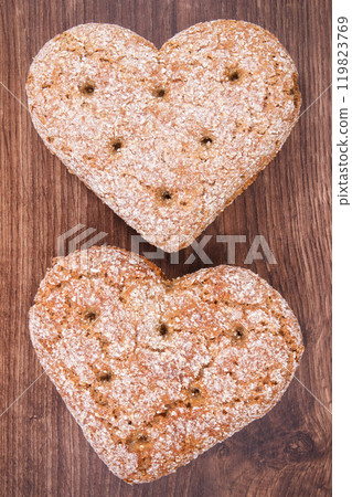 Bread in shape of heart baked from whole grain flour 119823769