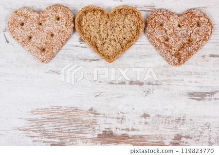 Fresh wholegrain bread in shape of heart for breakfast. Place for text on rustic background Fresh wholegrain bread in shape of heart for breakfast. Place for text on rustic background 119823770