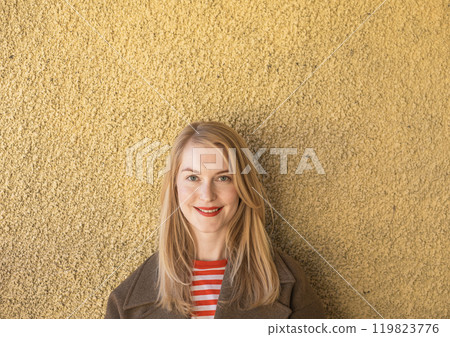 woman dressed warmly, enjoying the simple pleasures of an autumn day, highlighted by warm colors and textures woman dressed warmly, enjoying the simple pleasures of an autumn day, highlighted by warm colors and textures 119823776