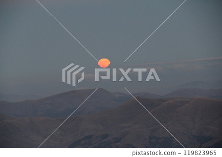 Stunning Landscape of a Full Moon Rising Over Majestic Mountains at Dusk with Stars in the Sky Stunning Landscape of a Full Moon Rising Over Majestic Mountains at Dusk with Stars in the Sky 119823965